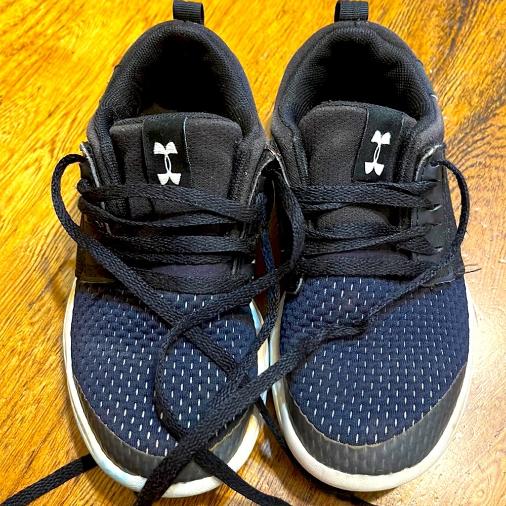 Under Armour youth sneakers. Used but still have plenty of wear left in them.